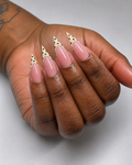 Cream polka dot french tips on long stiletto nails
